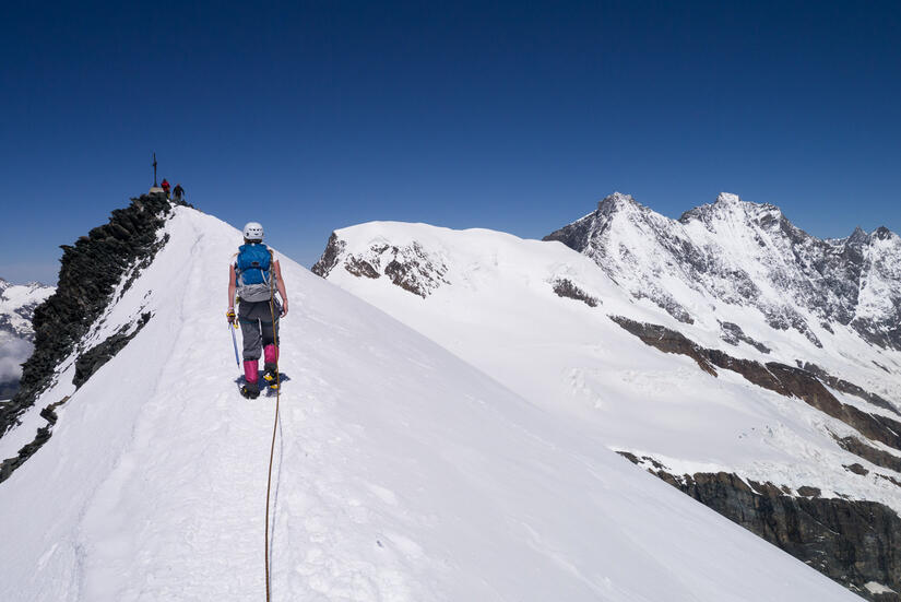 Walking up the snow arete to the summit