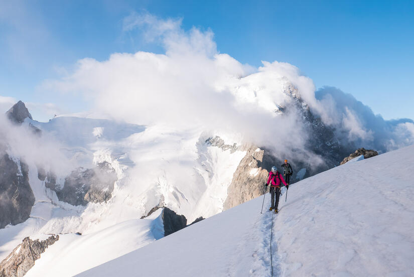 Becky in front of an atmospheric Barre des Ecrins